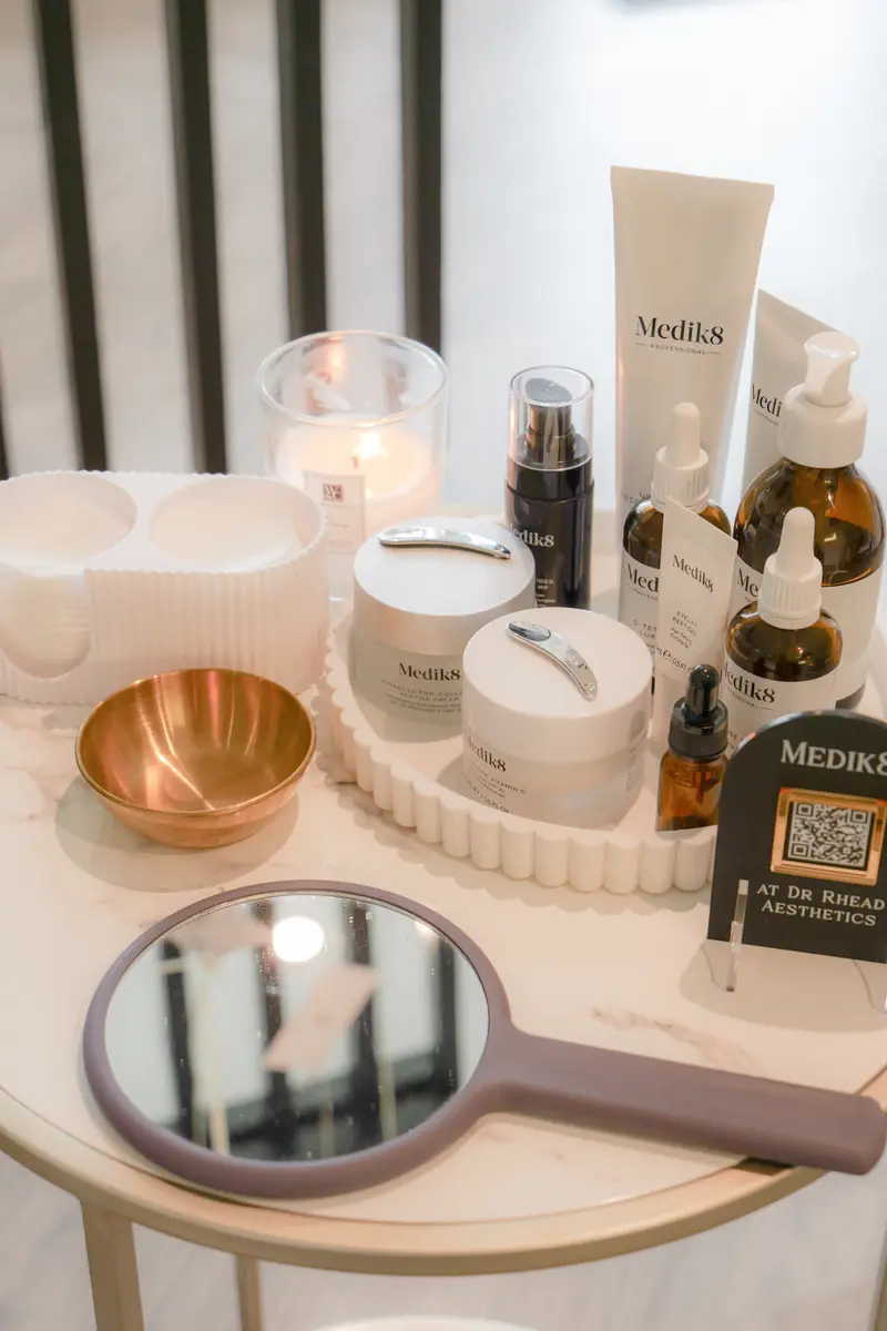 Close-up of the Medik8 skincare range on display at Dr Rhead Aesthetics, with a QR code stand to order products.