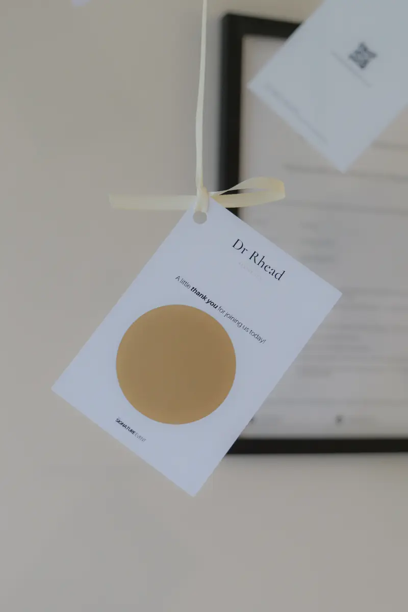 A Dr Rhead scratch card tag on a ribbon, a thank-you gift for guests at The Signature Event.